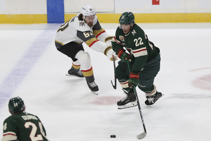 Minnesota Wild&#039;s Kevin Fiala (22) tries to maintain control of the puck against Vegas Golden Knights&#039; Mark Stone (61) during the first period of an NHL hockey game Wednesday, March 10, 2021, ...