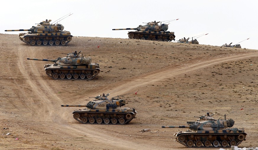 epa04423303 Turkish tanks guard the Syrian border after mortar shells hit Turkish territory in Suruc district, near Sanliurfa, Turkey 29 September 2014. Mortar shells from the ongoing battles between  ...