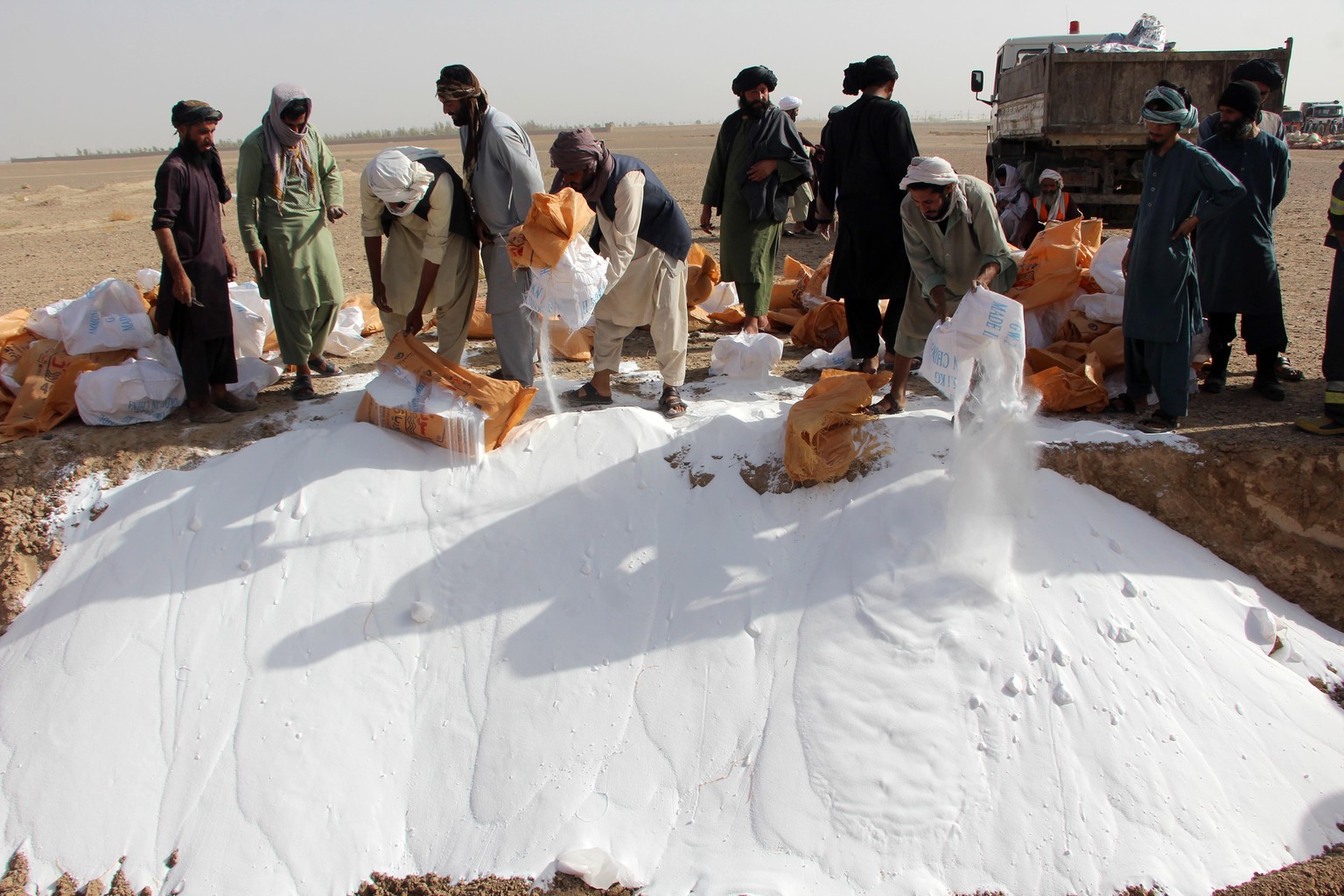 epa10845174 Afghani officials destroy narcotics and illegal substances during a ceremony in Kandahar, Afghanistan, 06 September 2023. Taliban authorities under the anti-narcotics management of the Sec ...