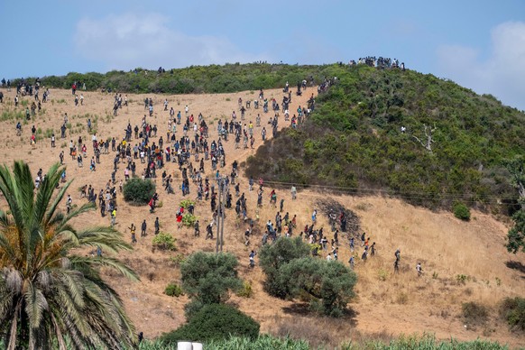 Migrants gather on a hill as they attempt crossing from the border town of Fnideq to the Spanish enclave of Ceuta, Saturday, Aug. 15, 2026. (AP Photo)
APTOPIX Morocco Spain Ceuta