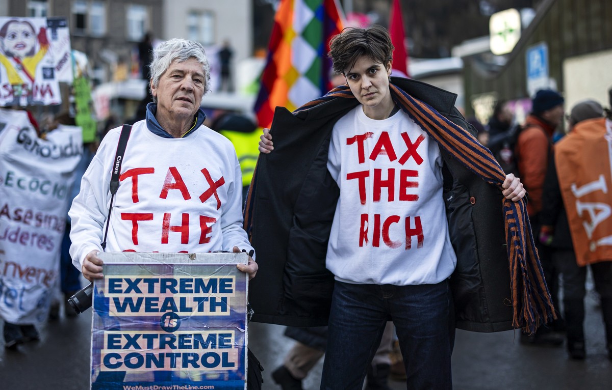 German-Austrian millionaire heiress and social activist Marlene Engelhorn, right, and Phil White of Patriotic Millionaires, left, attend a demonstration before the annual meeting of the World Economic ...