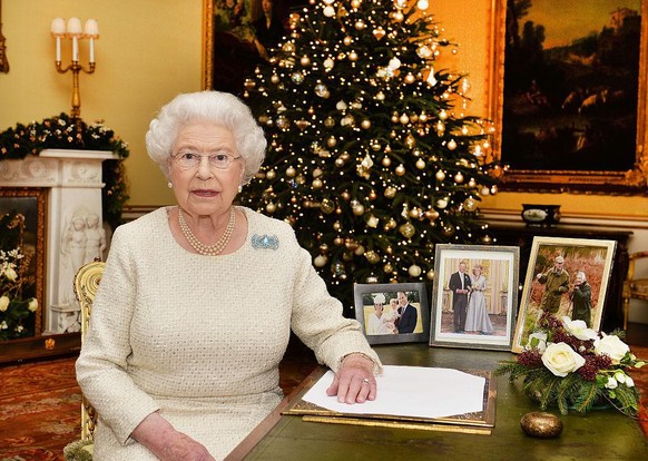 LONDON, ENGLAND - DECEMBER 25: Queen Elizabeth II sits at a desk in the 18th Century Room at Buckingham Palace, after recording her Christmas Day broadcast to the Commonwealth on December 25, 2015 in  ...
