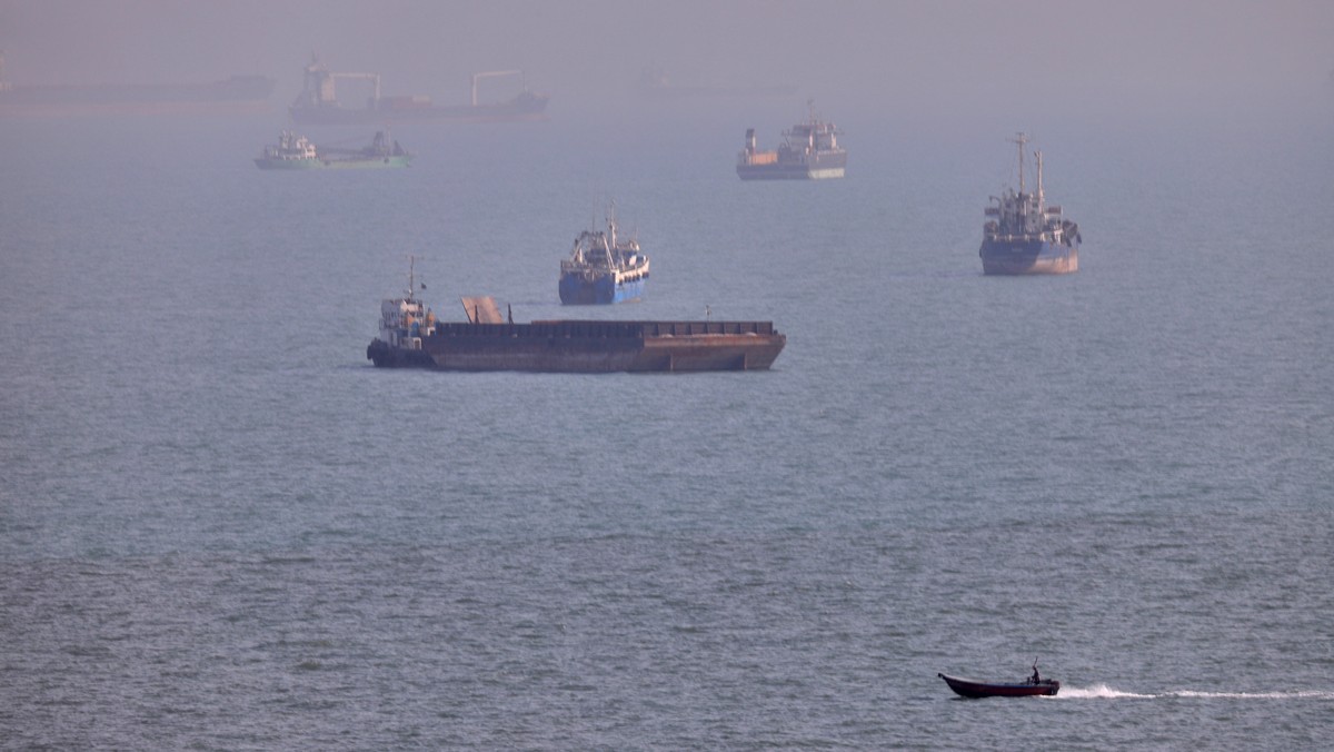 FILE - A small boat sails past cargo ships and other commercial vessels anchored in the Strait of Hormuz off Bandar Abbas, Iran, Wednesday, Aug. 5, 2026. (Amirhosein Khorgooi/ISNA via AP, File)
Iran U ...