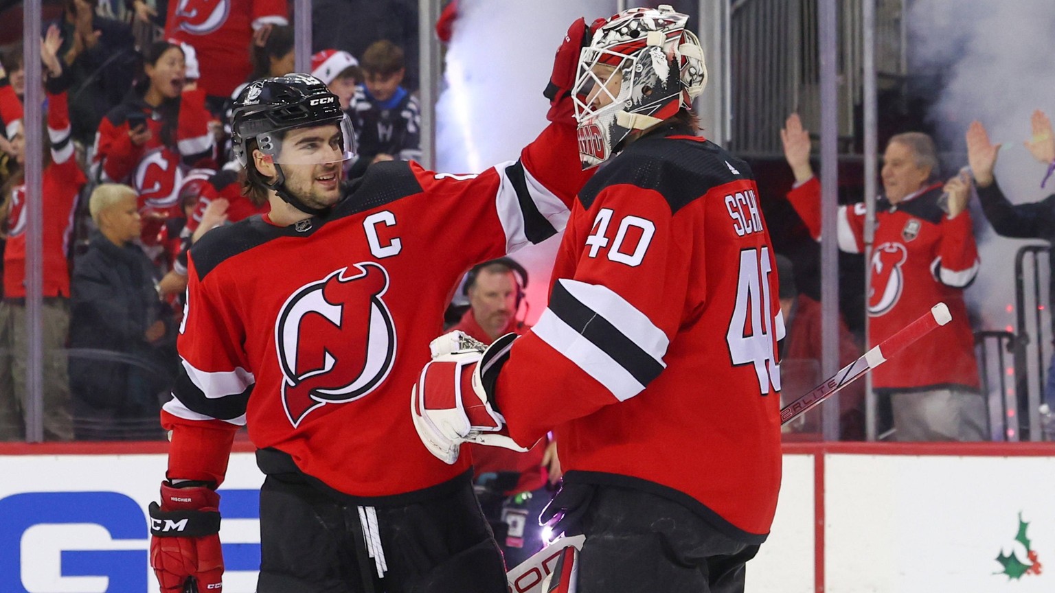 NHL, Eishockey Herren, USA New York Islanders at New Jersey Devils Nov 28, 2023 Newark, New Jersey, USA New Jersey Devils center Nico Hischier 13 and goaltender Akira Schmid 40 celebrate their win ove ...