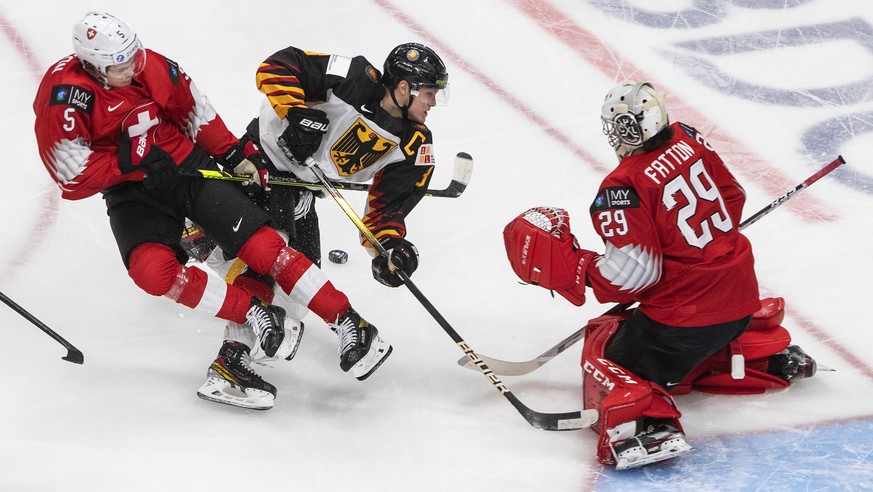 Germany&#039;s Tim Stutzle (8) is stopped by Switzerland goalie Thibault Fatton (29) as Giancarlo Chanton (5) defends during the first period of an IIHF World Junior Hockey Championship game Wednesday ...