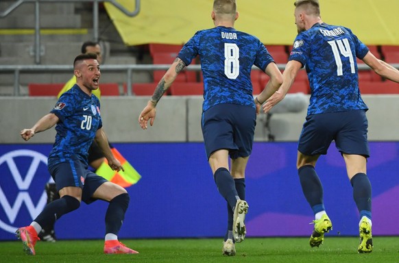 Slovakia's players Robert Mak, left, and Ondrej Duda, centre, celebrate after Slovakia's Milan Skriniar, right, scored the opening goal during the World Cup 2022 group H qualifying soccer ma ...