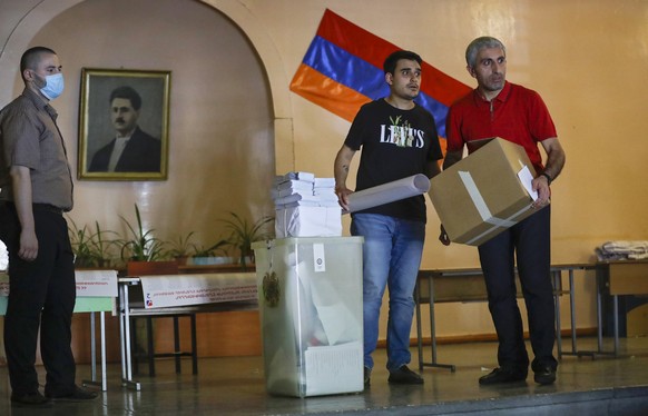 Election officials distribute election attributes to polling stations prior to the upcoming parliamentary elections in Yerevan, Armenia, Saturday, June 19, 2021. Armenians head to the polls Sunday for ...