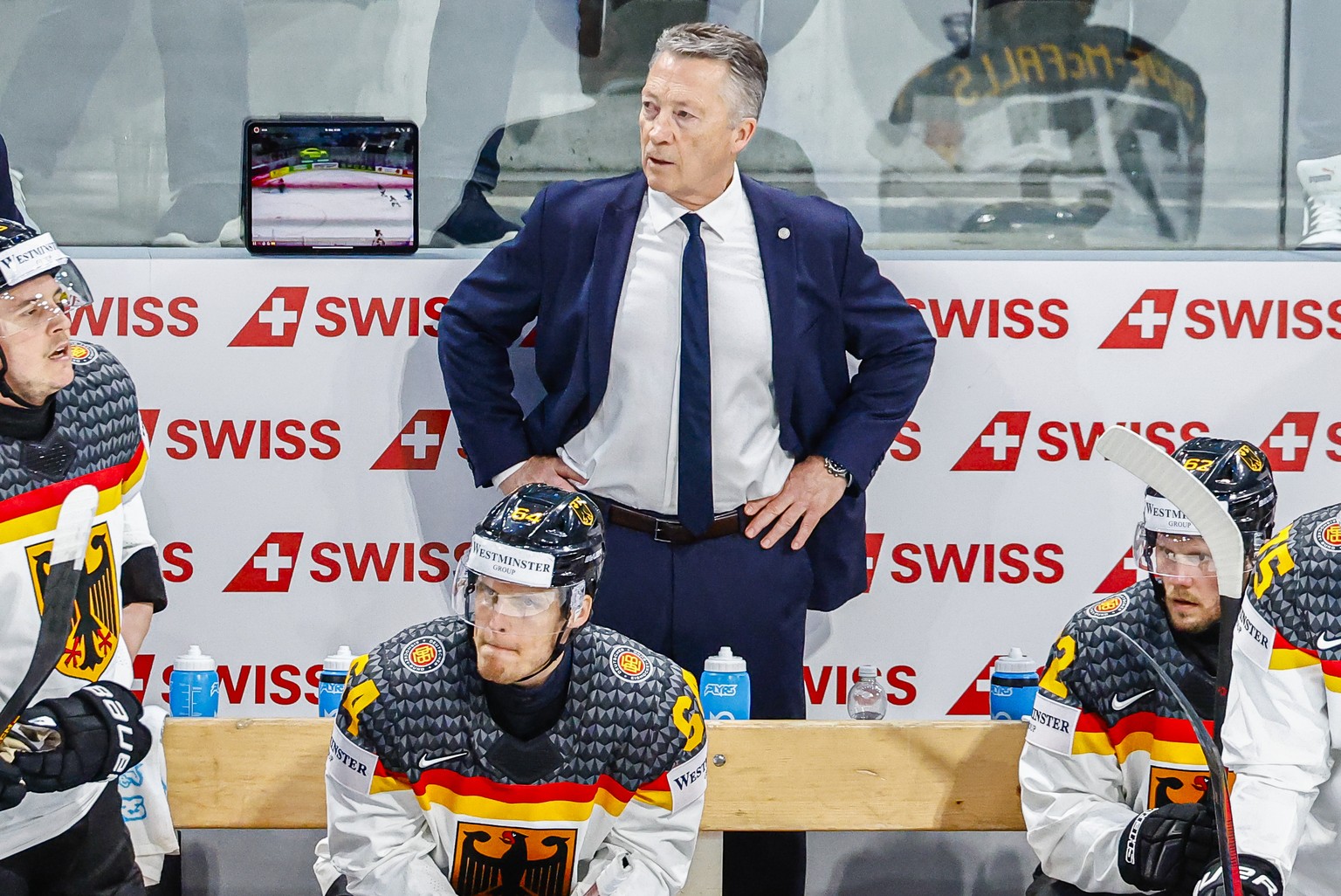 Harold Kreis, head coach of Germany, center, during the 2026 IIHF Men's Ice Hockey World Championship preliminary round group A game between Finland and Germany, at the Swiss Life Arena ice hocke ...