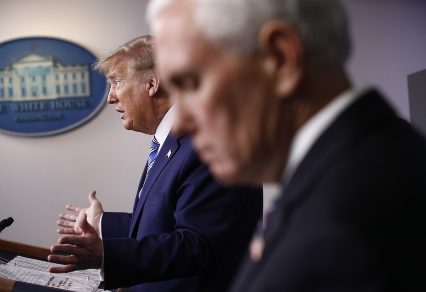 FILE - In this April 19, 2020, file photo Vice President Mike Pence, right, listens as President Donald Trump speaks during a coronavirus task force briefing at the White House in Washington. (AP Phot ...