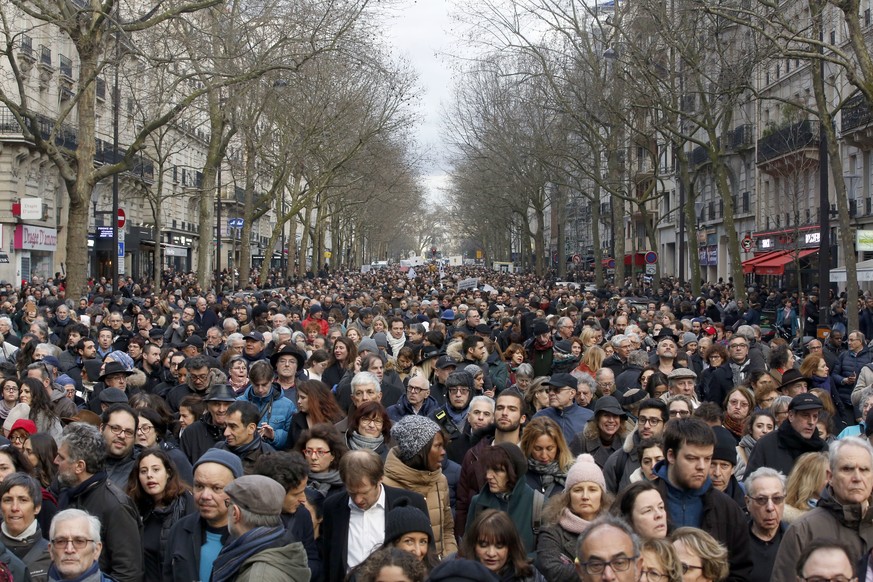 People attend a silent march to honor an 85-year-old woman who escaped the Nazis 76 years ago but was stabbed to death last week in her Paris apartment, apparently targeted because she was Jewish, and ...