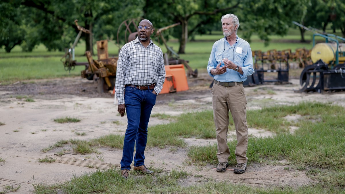 epa12305868 Democratic US Senator from Georgia Raphael Warnock (L) discusses tariff impacts with Georgia pecan farmer Jeb Barrow (R) at the Three Bees Pecan Farm in rural Keysville, Georgia, USA, 16 A ...