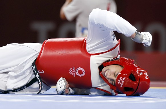 epa09363722 Refugee Olympic Team&#039;s Kimia Alizadeh Zenoorin reacts during her match against China&#039;s Zhou Lijun in the Taekwondo Women -57kg quarterfinal of the Tokyo 2020 Olympics at the Maku ...