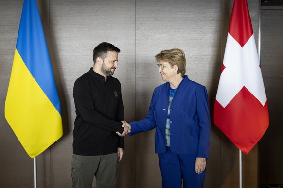 Ukrainian President Volodymyr Zelenskyy, left, and Swiss Federal President Viola Amherd, right, shake hands during the Summit on peace in Ukraine, in Stansstad near Lucerne, Switzerland, Saturday, Jun ...