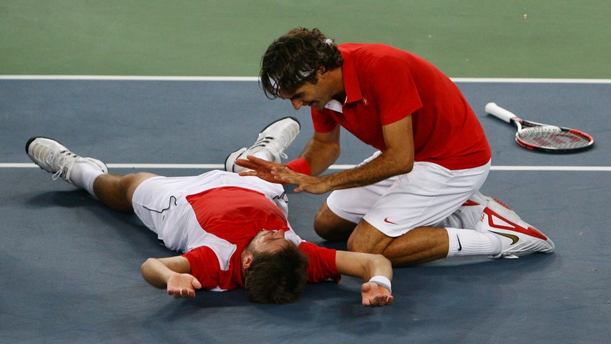 BEIJING - AUGUST 16: Roger Federer (right) and Stanislas Wawrinka of Switzerland celebrate after defeating Thomas Johansson and Simon Aspelin of Sweden during the men&#039;s doubles gold medal tennis  ...