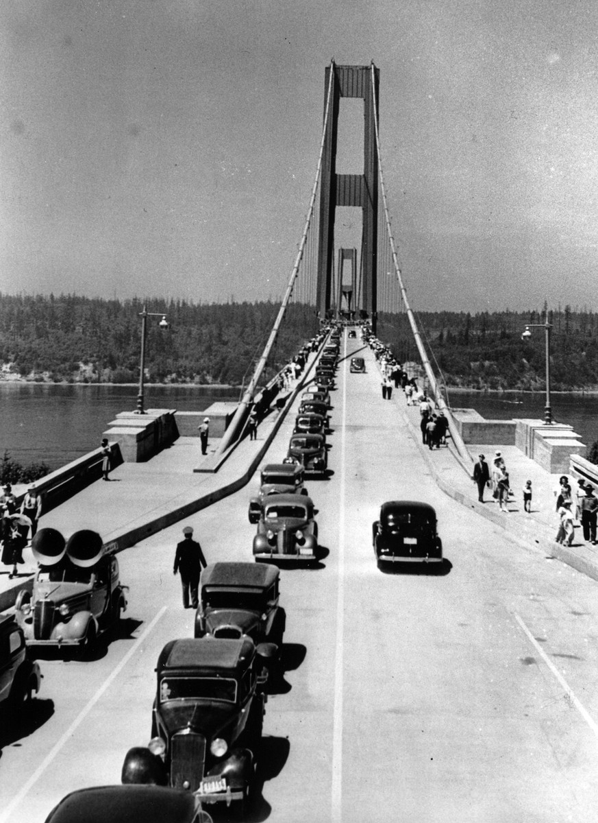 The $6,400,000 Narrows bridge at Tacoma, Wash., opened July 1, 1940. Pictured are the first cars crossing the entire 5,000 foot span. The steel towers are 425 feet above water. This view is from the e ...