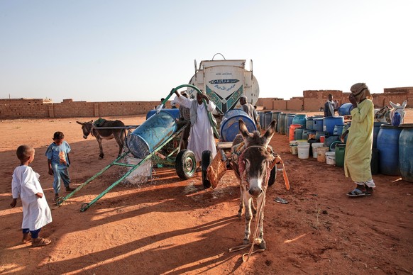 People fill water containers at a free distribution point due to water outages in Khartoum, Sudan, Friday, Jan. 30, 2026. (AP Photo/Marwan Ali).Sudan Daily Life