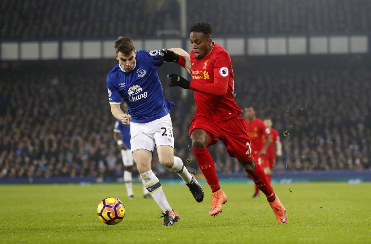 Britain Football Soccer - Everton v Liverpool - Premier League - Goodison Park - 19/12/16 Everton's Seamus Coleman in action with Liverpool's Divock Origi Action Images via Reuters / Carl Re ...
