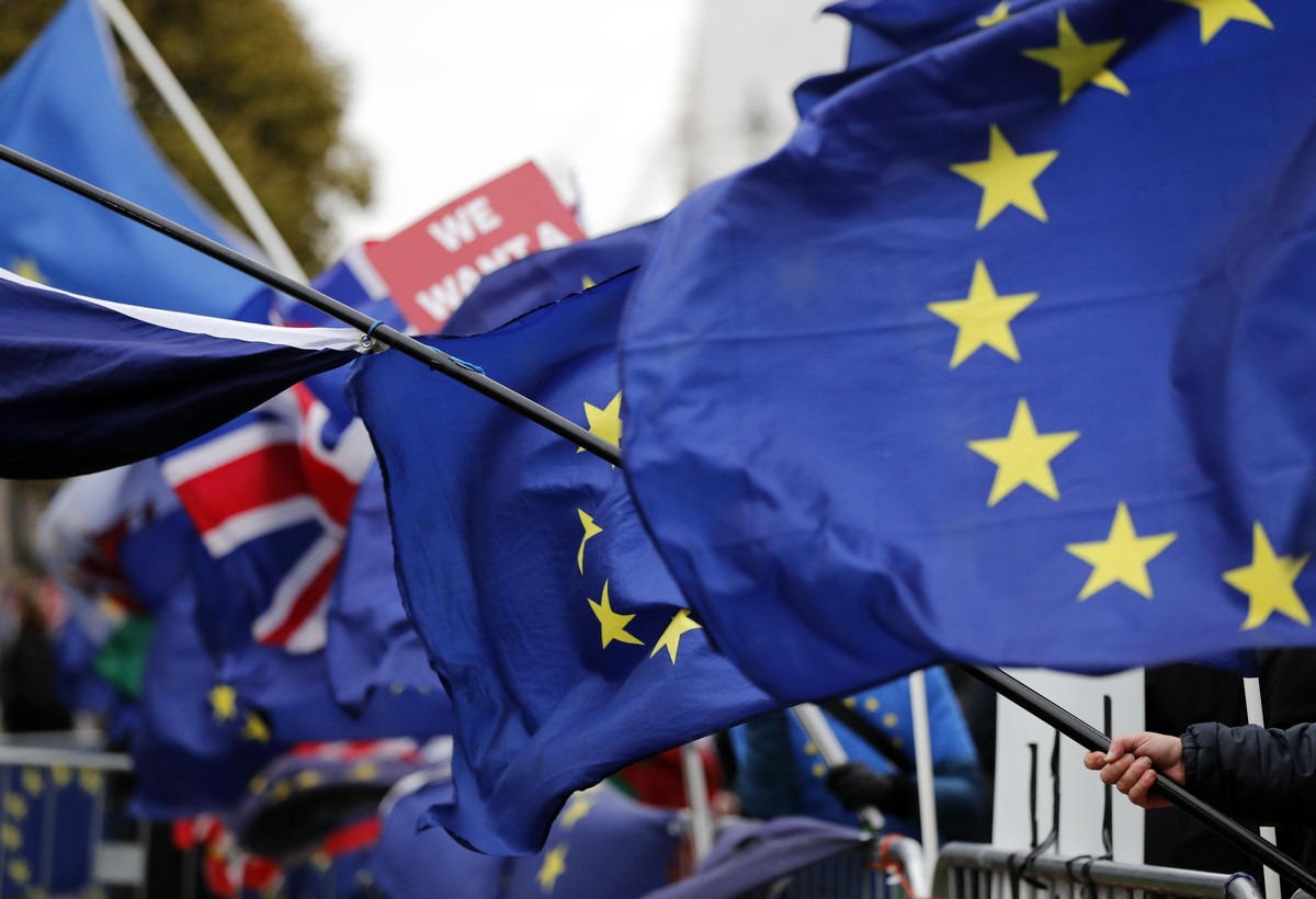 The EU and British flags wave at the demonstrations area near the parliament building in London, Wednesday, Jan. 16, 2019. British lawmakers overwhelmingly rejected Prime Minister Theresa May's d ...