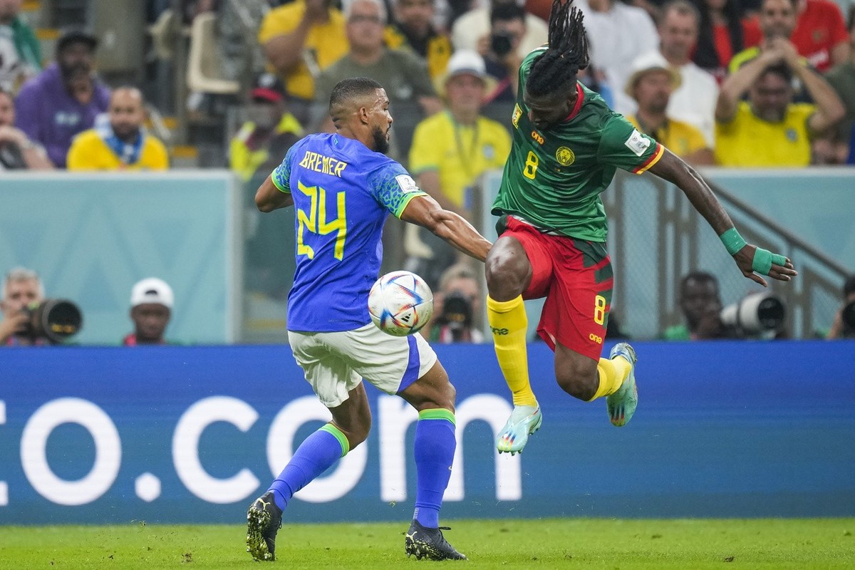 Cameroon's Andre-Frank Zambo Anguissa, right, battles for the ball with Brazil's Bremer during the World Cup group G soccer match between Cameroon and Brazil, at the Lusail Stadium in Lusail ...