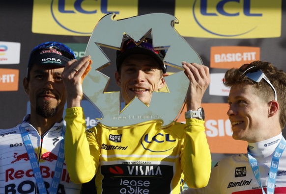epa12822172 Danish rider Jonas Vingegaard (C) of Team Visma-Lease celebrates on the podium winning the Paris-Nice 2026 cycling race, flanked by second placed Colombian rider Daniel Felipe Martinez Pov ...