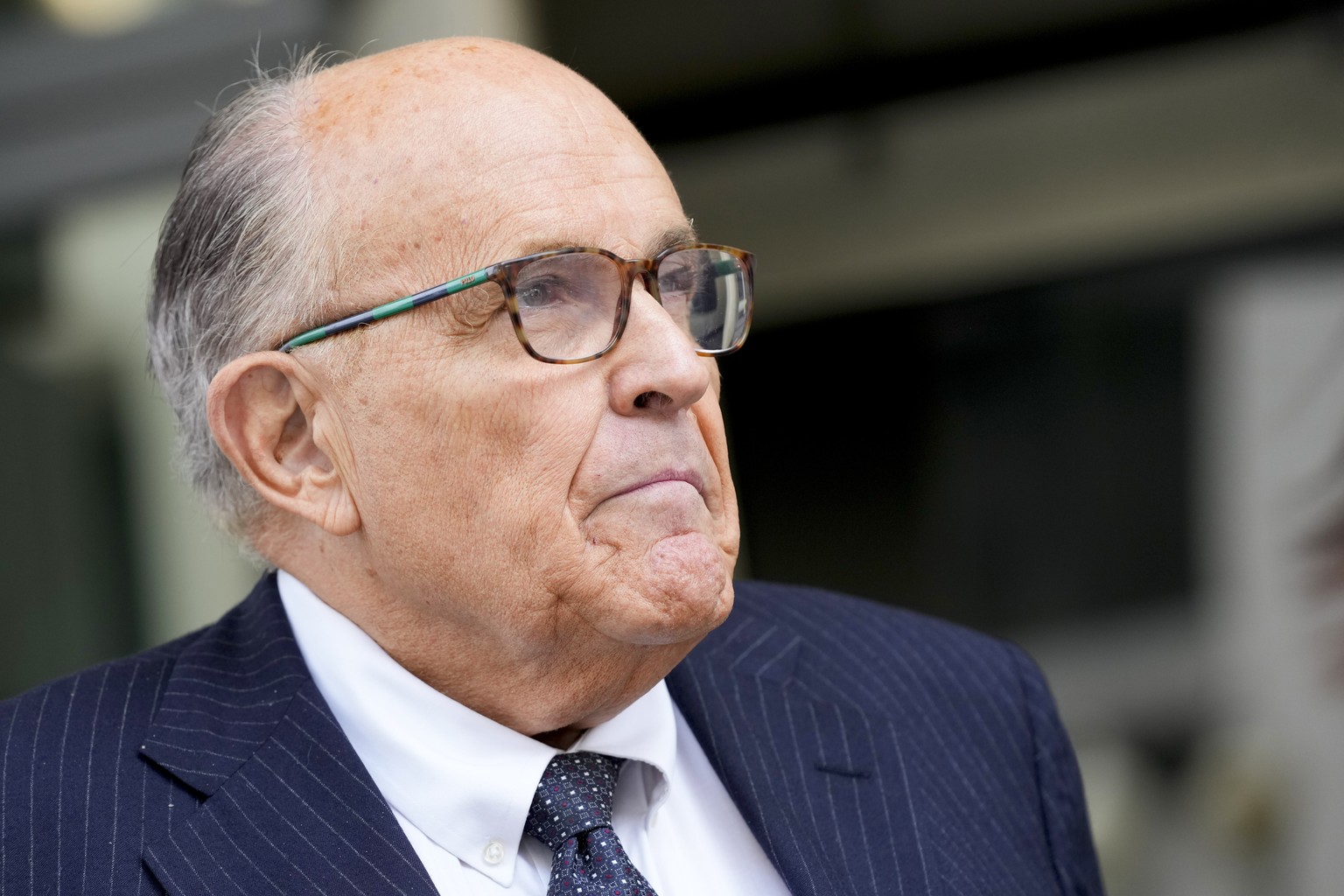 FILE - Rudy Giuliani speaks with reporters as he departs the federal courthouse, Friday, May 19, 2023, in Washington. A review panel says former New York Mayor Rudolph Giuliani should be disbarred in  ...