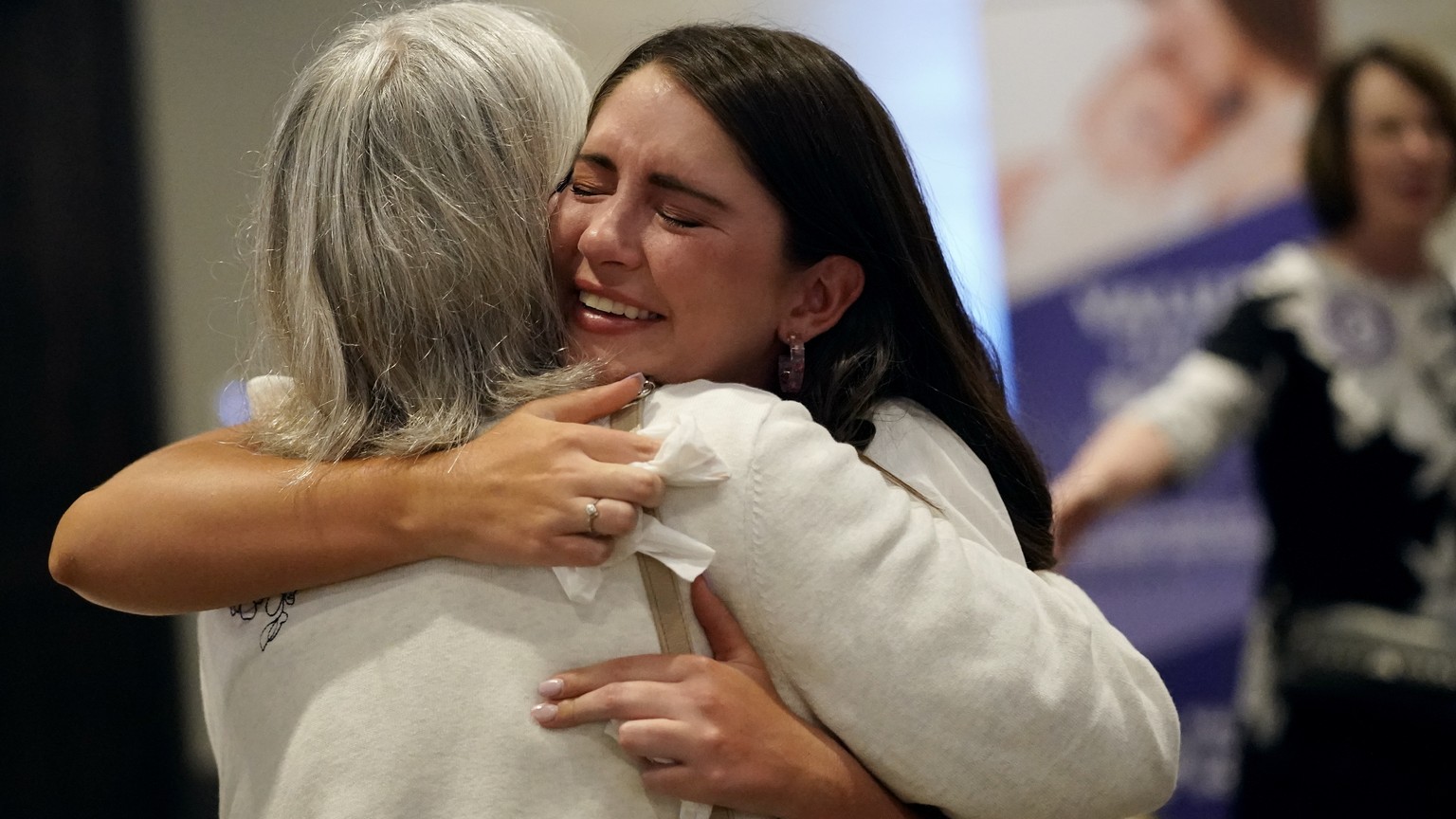 People hug during a Value Them Both watch party after a question involving a constitutional amendment removing abortion protections from the Kansas constitution failed Tuesday, Aug. 2, 2022, in Overla ...