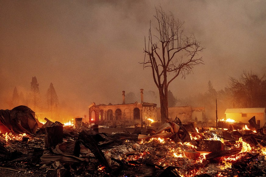 Buildings burn as the Dixie Fire tears through the Greenville community of Plumas County, Calif., on Wednesday, Aug. 4, 2021. The fire leveled multiple historic buildings and dozens of homes in centra ...