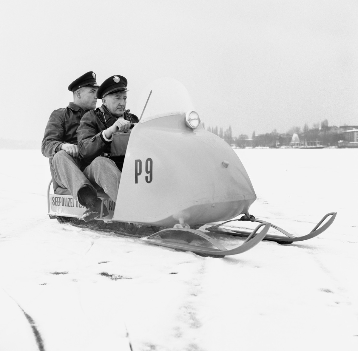Two officials of the water guards in a snowmobile on the frozen Lake Zurich on the first day of the complete freeze-over of the lake, pictured on February 1, 1963, in Zurich, Switzerland. (KEYSTONE/PH ...