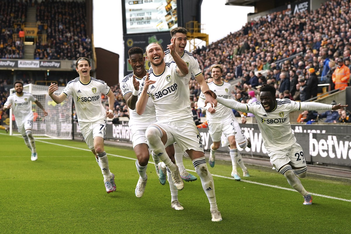 Leeds United's Luke Ayling, centre, celebrates scoring his side's second goal of the game with teammates during the English Premier League soccer match between Wolverhampton Wanderers and Le ...