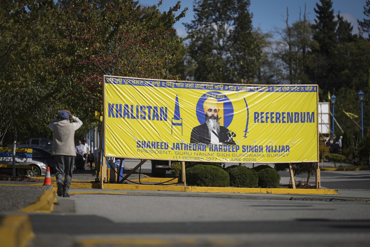 A photograph of late temple president Hardeep Singh Nijjar is seen on a banner outside the Guru Nanak Sikh Gurdwara Sahib in Surrey, British Columbia, on Monday, Sept. 18, 2023, where temple president ...