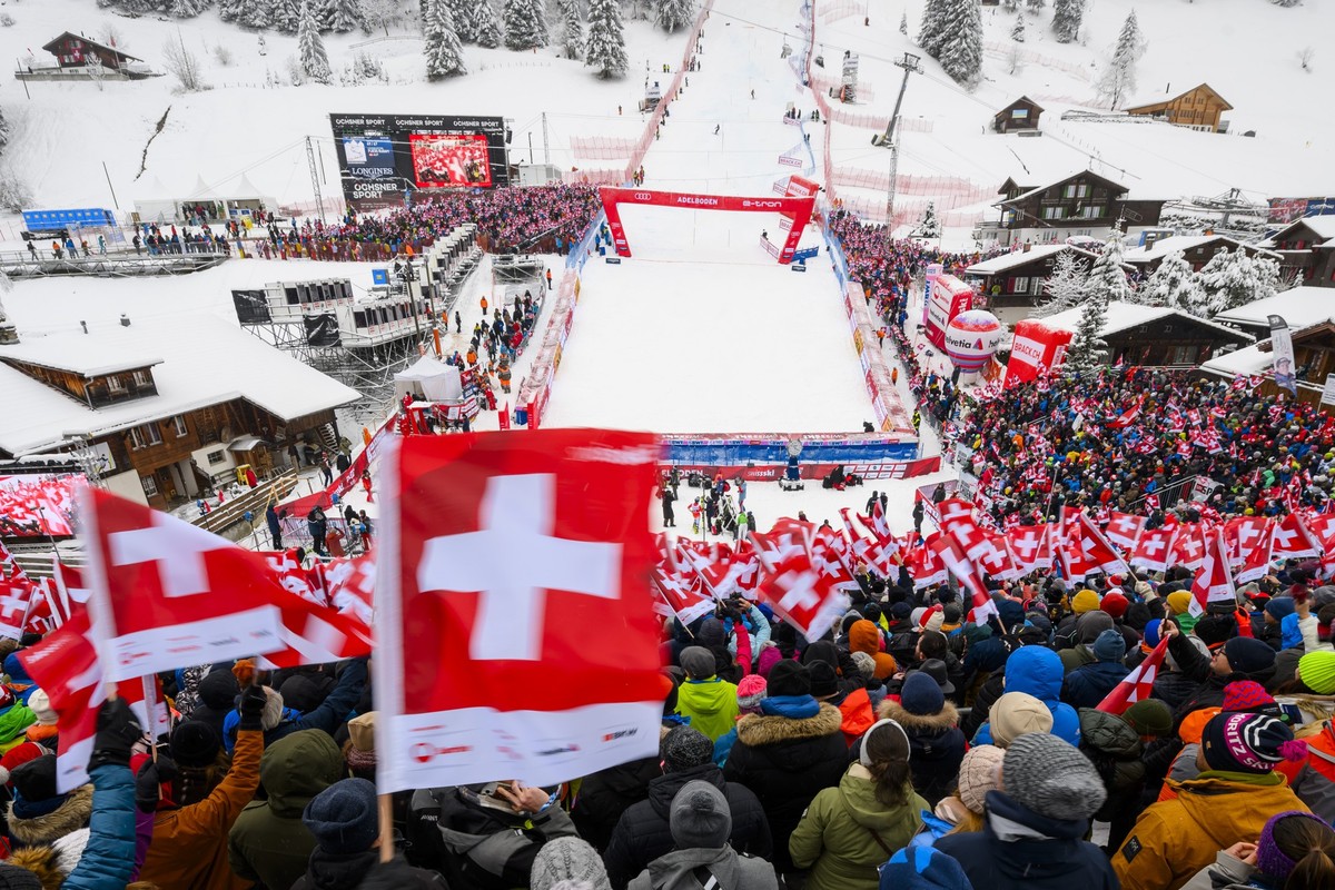 Spectators celebrate during the first run of the men's slalom race at the Alpine Skiing FIS Ski World Cup in Adelboden, Switzerland, Sunday, January 7, 2024. (KEYSTONE/Jean-Christophe Bott)