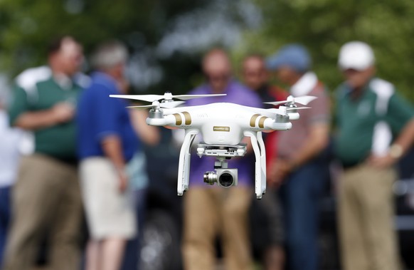 In this June 11, 2015, photo, a DJI Phantom 3 drone is flown by Matthew Creger, marketing director for Intelligent UAS, during a drone demonstration at a farm and winery on potential use for board mem ...