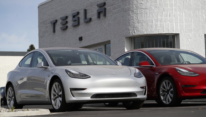 In this Sunday, April 15, 2018, photograph, unsold 2018 Model 3 Long Range vehicles sit on a Tesla dealer&#039;s lot in the south Denver suburb of Littleton, Colo. (AP Photo/David Zalubowski)