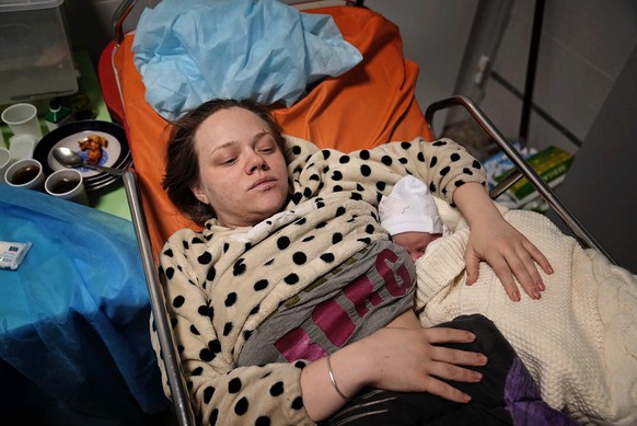 FILE - Mariana Vishegirskaya lies in a hospital bed after giving birth to her daughter Veronika, in Mariupol, Ukraine, Friday, March 11, 2022. Vishegirskaya survived the Russian airstrike on a childre ...
