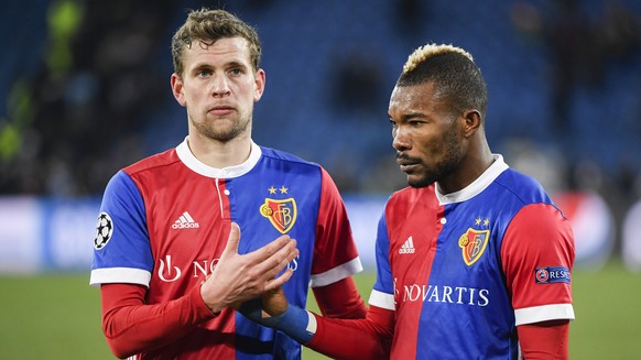 Basel&#039;s Fabian Frei, left, and Geoffroy Serey Die show dejection after the UEFA Champions League round of sixteen first leg soccer match between Switzerland&#039;s FC Basel 1893 and England&#039; ...
