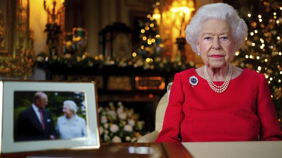 In this undated photo issued on Thursday Dec. 23, 2021, Britain&#039;s Queen Elizabeth II records her annual Christmas broadcast in Windsor Castle, Windsor, England. The photograph at left shows The Q ...