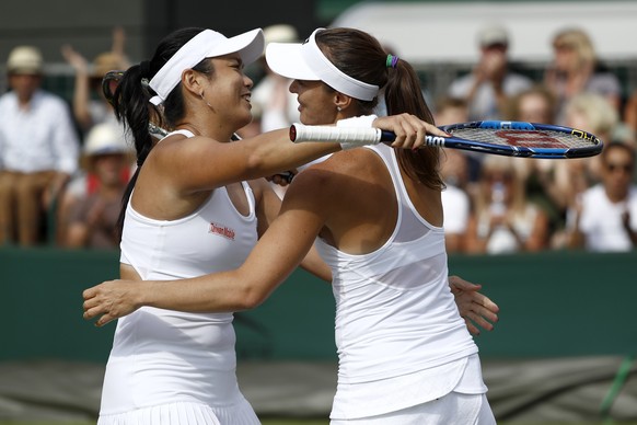 Martina Hingis of Switzerland, right, and Yung-Jan Chan of Chinese Taipei celebrate after winning their ladies doubles match against Kirsten Flipkens of Belgium and Sania Mirza of India, during the Wi ...