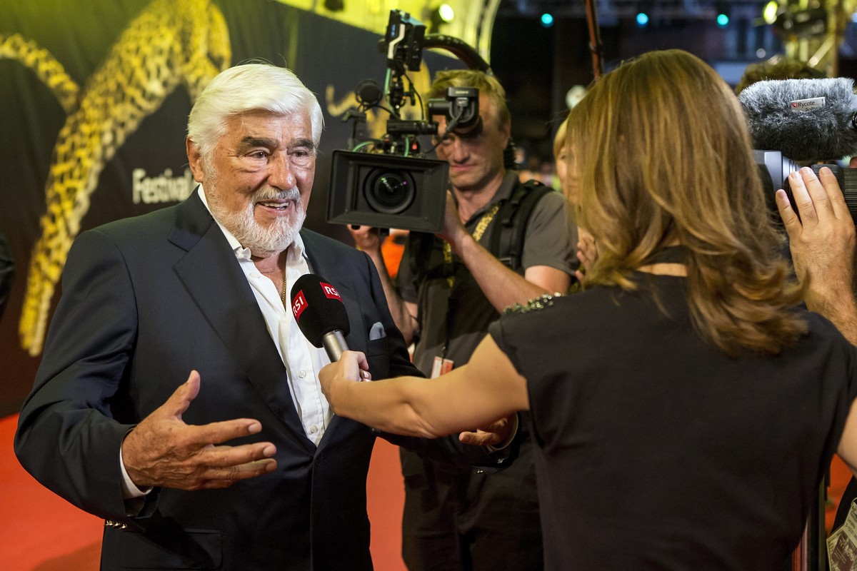 epa05462885 German actor Mario Adorf (L) is interviewed on the red carpet during the 69th Locarno International Film Festival, at the Piazza Grande in Locarno, Switzerland, 07 August 2016. The Festiva ...