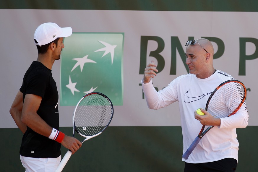 epa05989103 Novak Djokovic (L) of Serbia talks with his new coach Andre Agassi (R) of US during a training session few days ahead of the French Open tennis tournament at Roland Garros in Paris, France ...