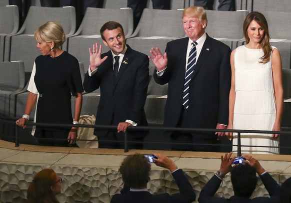 US-President Donald Trump, 2nd right, and his wife Melania, right, as well as French President Emmanuel Macron, 2nd left, and his wife Brigitte arrive at the Elbphilharmonie concert hall on the occasion of the G-20 summit in Hamburg, Germany, Friday, July 7, 2017. (Christian Charisius/Pool Photo via AP)