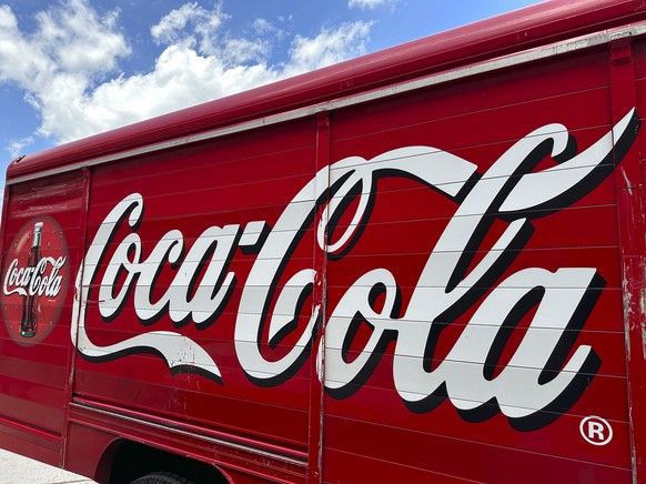 FILE - The Coca-Cola logo adorns the side of a delivery truck May 15, 2024, in southeast Denver. Coca-Cola reports earnings on Tuesday, July 23, 2024. Coca-Cola Co. said Friday, Aug. 2, 2024, it will  ...