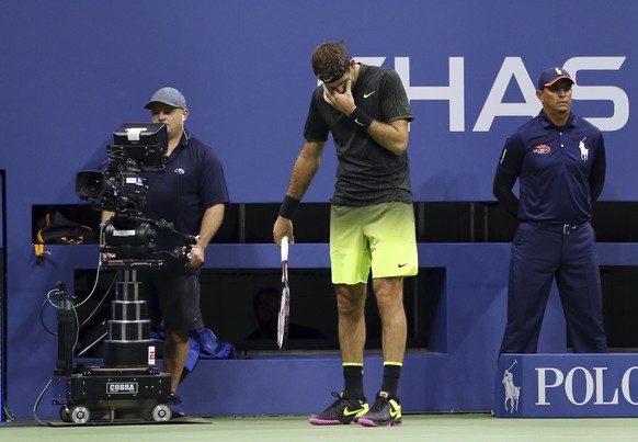 Juan Martin del Potro, of Argentina, reacts as fans cheer for him late in his match against Stan Wawrinka, of Switzerland, during the quarterfinals of the U.S. Open tennis tournament, early Thursday,  ...