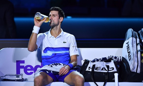 epa09587313 Novak Djokovic of Serbia drinks during a break in his group stage match against Andrey Rublev of Russia at the Nitto ATP Finals tennis tournament in Turin, Italy, 17 November 2021. EPA/Ale ...