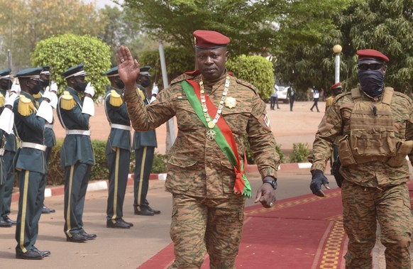 epa09796633 Lieutenant-Colonel Paul-Henri Damiba (C) President of Burkina Faso, waves after his inauguration as the President of the Transition in Ouagadougou, Burkina Faso, 02 March 2022. Following t ...