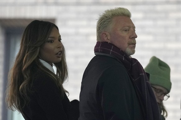 Former Wimbledon tennis champion Boris Becker, right, looks back as he waits in a queue to get into Southwark Crown Court in London, Monday, March 21, 2022. Becker is in court accused of filing to han ...