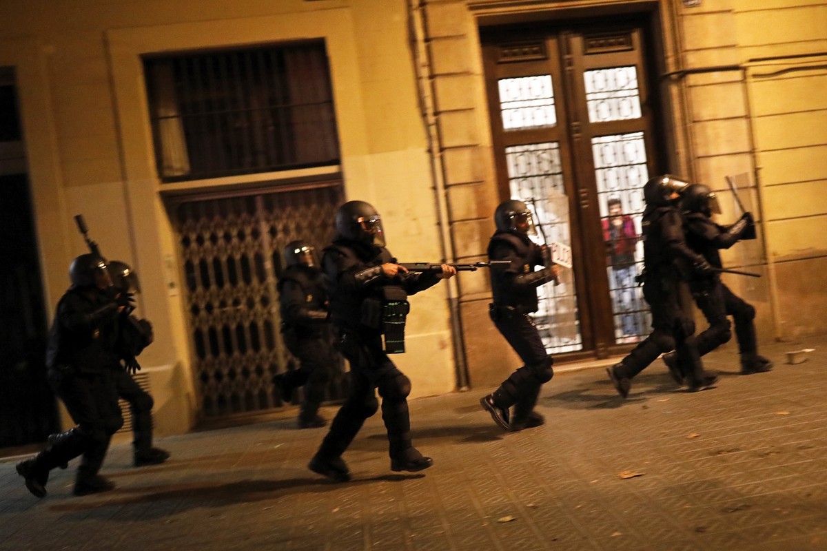 Police in riot gear moves after protestors during clashes in Barcelona, Spain, Wednesday, Oct. 16, 2019. Spain's government said Wednesday it would do whatever it takes to stamp out violence in C ...