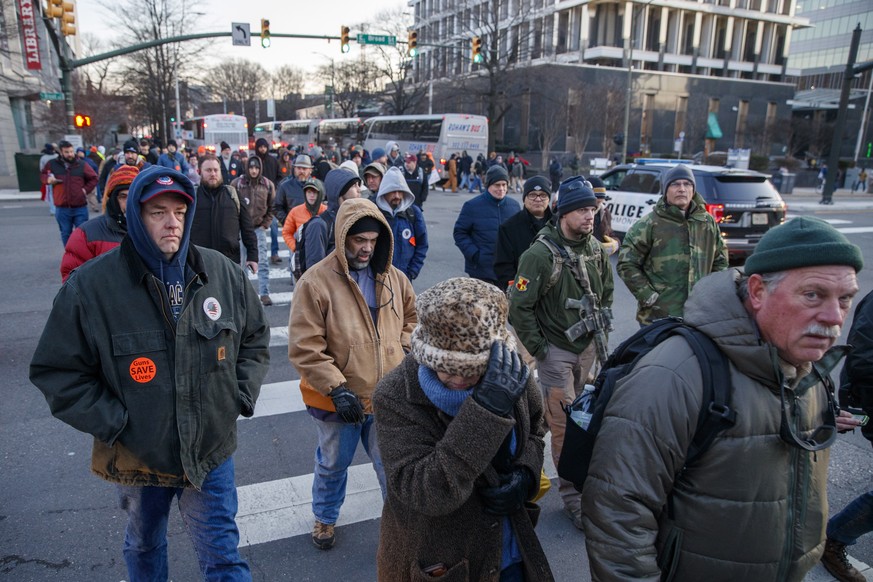 epa08144486 Gun-rights supporters gather for a rally outside the Virginia state capitol in Richmond, Virginia, USA, 20 January 2020. Virginia Citizens Defense League organized the rally to lobby again ...