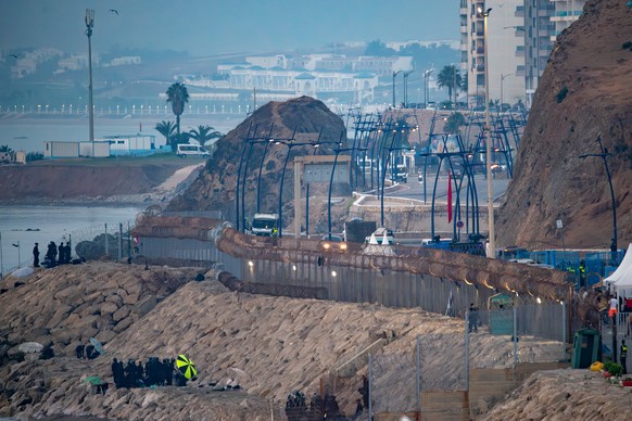 Morocco security forces, bottom left, patrol the Spanish-Moroccan border seen from the Spanish enclave of Ceuta, Saturday, Aug. 15, 2026. (AP Photo/Antonio Sempere)
Spain Ceuta