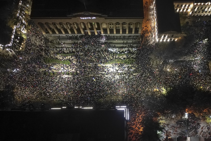 Demonstrators rally outside the parliament&#039;s building, top, to protest the government&#039;s decision to suspend negotiations on joining the European Union for four years in Tbilisi, Georgia, on  ...