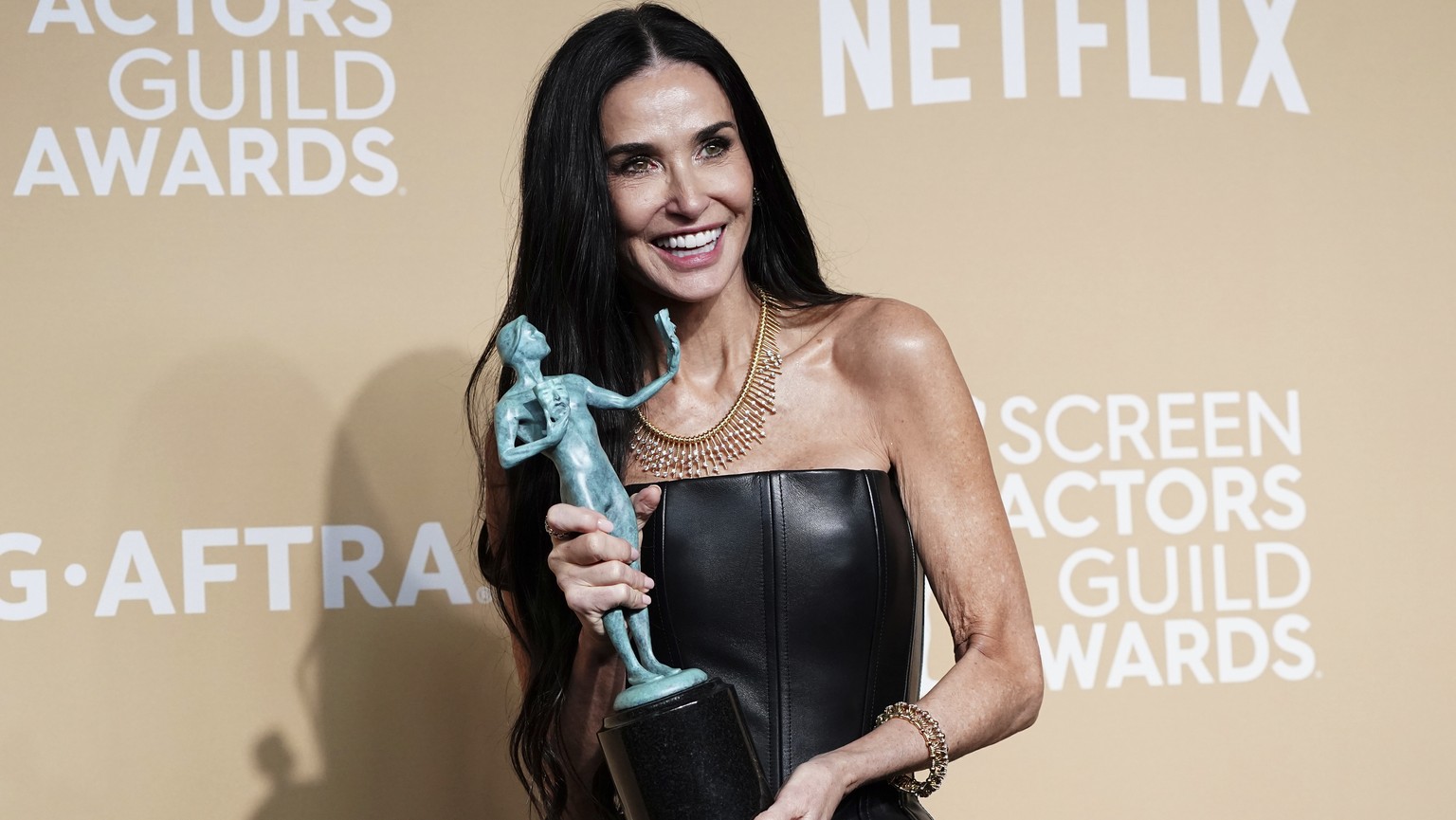 Demi Moore poses in the press room with the award for outstanding performance by a female actor in a leading role for &quot;The Substance&quot; during the 31st annual Screen Actors Guild Awards on Sun ...
